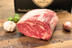 Pictured is an uncooked Linz Heritage Angus USDA prime rib roast, also know as prime rib, on a cutting board