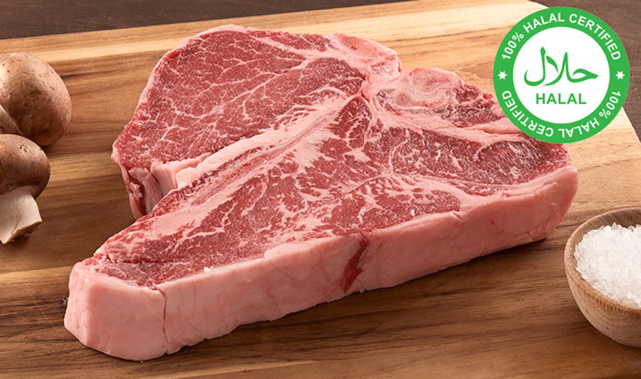 Pictured is an uncooked USDA Prime Halal porterhouse on a cutting board.