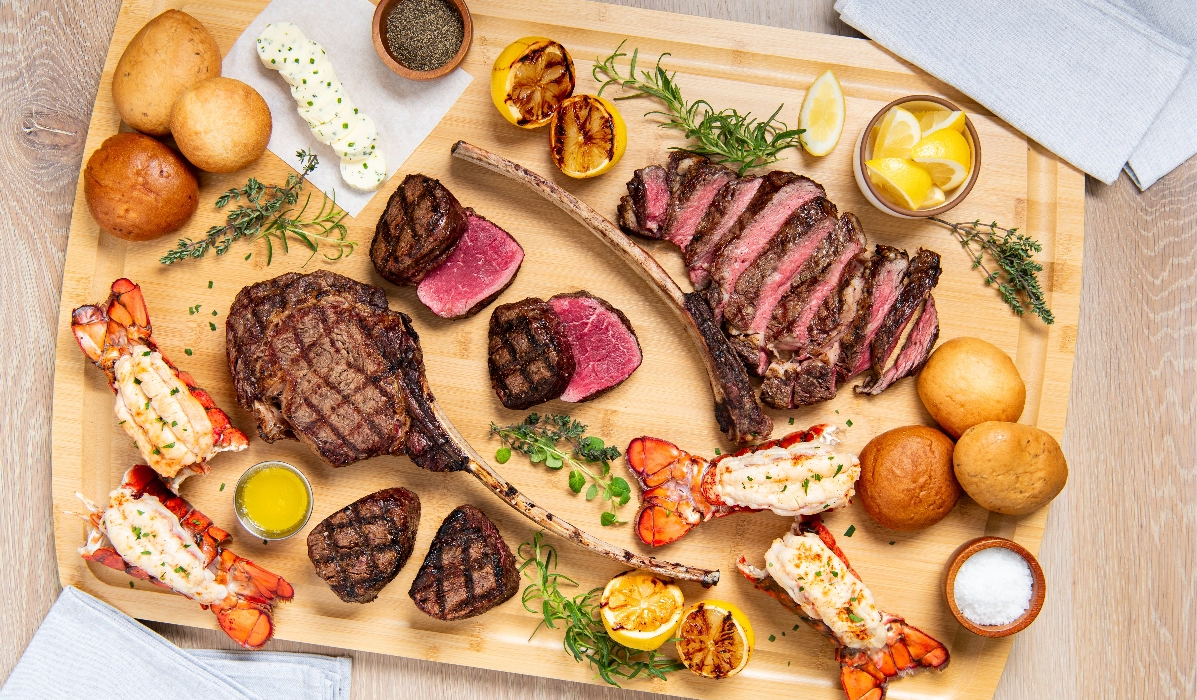 Assorted meats and sides on a wooden board