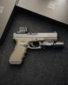 Custom Glock 17 Gen 3 MOS OD Green with Holosun EPS, Radian Guardian, ZEV barrel, SureFire X300 Ultra, factory case, and accessories.
