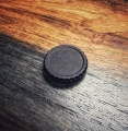 ACRO P2 tool-free billet battery cap with tactile grip and dual O-rings for fast, secure field battery changes on compatible enclosed optics.