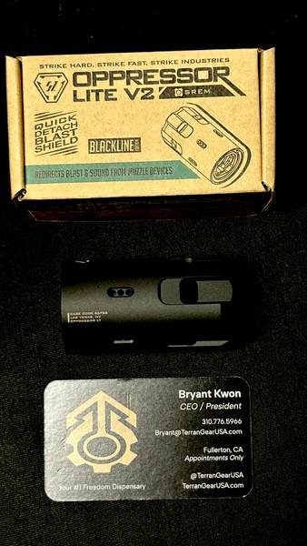 Strike Oppressor Lite V2 — 5.0 oz concussion reduction device with hardened steel core, aluminum shell, 18 vent holes, and fast QD mount for SREM-compatible muzzle devices. Lightweight, quick-attach blast redirector for training and close-quarters use