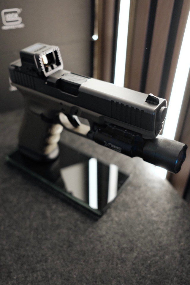 Custom Glock 17 Gen 3 MOS OD Green with Holosun EPS, Radian Guardian, ZEV barrel, SureFire X300 Ultra, factory case, and accessories.