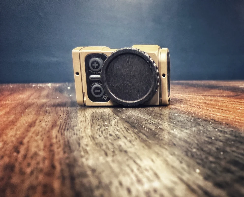 ACRO P2 tool-free billet battery cap with tactile grip and dual O-rings for fast, secure field battery changes on compatible enclosed optics.