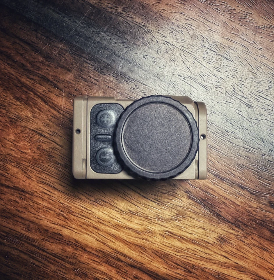 ACRO P2 tool-free billet battery cap with tactile grip and dual O-rings for fast, secure field battery changes on compatible enclosed optics.