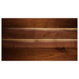 Detailed perspective of a Walnut face grain pattern, highlighting the organic interplay between deep chocolate heartwood and lighter, subtle highlights found in superior-grade American Walnut.