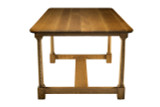 Short side view of White Oak Farmhouse Dining Table showing rounded rectangular top, tapered white oak legs, and lower stretcher base
