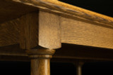 Close-up of White Oak Farmhouse Dining Table corner showing premium oak grain, apron joinery, rounded edge, and turned leg detail