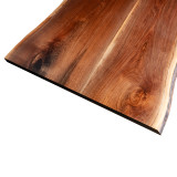 Top-down detail of the front edge of a Black Walnut book matched countertop, highlighting the mirrored grain radiating from the center seam and the natural, de-barked character of the live edge perimeter.