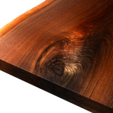 Close-up of a Black Walnut corner detail showing a natural, swirling knot and the shimmering chatoyance of the grain under a high-performance acrylic polyurethane finish.