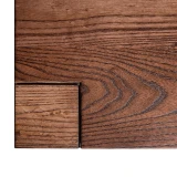 Overhead left corner detail of Signature Parsons Dining Table highlighting book matched leg top cap, ash grain, and precise joinery