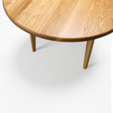 Angled close-up of the Horizon Dining Table highlighting white oak grain, rounded end, and handcrafted sculpted edge