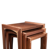 Tight detail of modern walnut nesting tables showing layered nesting configuration, mitered walnut legs, and handcrafted joinery