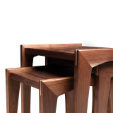 Open left view of walnut nesting table set highlighting flexible three-table design, solid walnut construction, and refined silhouette