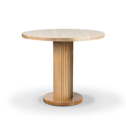 A beautiful modern dining table in a low wide angle shot. The soft lighting highlights the clean design and smooth curves of the piece crafted from solid maple.