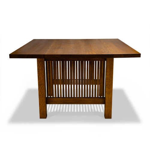 Front view of HLC Furniture Frank Lloyd Wright Inspired Dining Table in quarter-sawn white oak, showing slatted base panel and its shadow