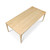 An angled perspective of the solid maple dining table, highlighting the continuous, linear variations of the edge grain butcher block surface and the elegant downward taper of the solid wood legs.