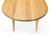 Close-up of the Horizon Dining Table’s white oak racetrack top, natural wood grain, and softly sculpted edge profile