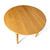Overhead view of the Cascade Round Dining Table showing natural hardwood grain, round top, and clean modern silhouette