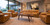 HLC Furniture Solid walnut modern coffee table in a contemporary living room with tan leather seating, woven rug, large windows, and warm modern decor.