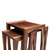 Angled overhead view of modern walnut nesting tables showing three-table configuration, natural grain, and architectural design