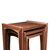 Close-up of nested walnut tables with solid wood construction, rich grain variation, and contrasting maple spline details