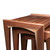 Close-up of large walnut nesting table showing mitered leg construction, curved inner profile, and precision maple spline joinery