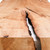 Close-up of Rift Credenza waterfall maple slab showing live edge, natural voids, organic grain, and sculptural hardwood detail