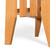 Detail of the tapered white oak legs narrowing toward the floor beneath the lower shelf