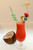 A tropical fruit blend with layered colors and a reefy stirrer.