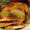 Poche's Turducken with Cornbread & Rice Dressing, whole cooked turducken served with slices revealing stuffing and meat