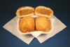 Cajun Original Crab Pistolettes 24 Pack, image of golden fried crab filled pastry puffs on a white basket with a divided filling revealed in the cut-open pastry.