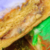 Gambino's Praline King Cake with icing on side, a traditional festive cake with creamy praline filling and colorful icing.