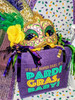 Creole Foods of Louisiana Mini King Cake Date Night, colorful Mardi Gras-themed decorative mask and purple bag with Mardi Gras greeting, celebrating festive Louisiana cuisine and Mardi Gras traditions.
