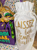 Creole Foods of Louisiana Mini King Cake Date Night, decorative Mardi Gras mask, purple gift bag with ribbons, and festive confetti background for celebration.