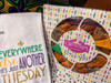 Creole Foods of Louisiana King Cake Box, decorated with colorful Mardi Gras-themed patterns and containing traditional King Cakes.