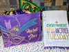 Creole Foods of Louisiana King Cake Box, colorful Mardi Gras themed gift bag and towel with festive messages.