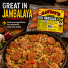 Savoie's Smoked Hot Pork Sausage 16oz, package of smoked hot pork sausages displayed above a skillet of jambalaya with sausage slices and vegetables.