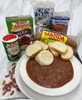 Creole Foods of Louisiana DIY Red Bean Meal Kit, assorted ingredients including beans, sausage, bread, rice, and seasoning packets on a plate.