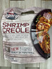 Legacy Foods Legacy Shrimp Creole Served Over Rice Pilaf, frozen microwave steam bag package showing shrimp creole with rice, zucchini, and squash on a black plate.