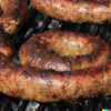 Creole Foods of Louisiana Ultimate Boudin Sampler Kit, close-up of grilled Cajun boudin sausages with seasoned, spicy casing.