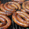 Creole Foods of Louisiana Ultimate Boudin Sampler Kit, close-up of grilled Louisiana boudin sausages with a crispy outer skin and a glossy appearance.
