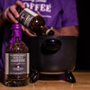 PJ's Whiskey Barrel Aged Coffee - Limited Edition, bottled coffee beans with purple wax seal, being prepared with a coffee roaster.