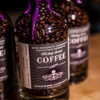 PJ's Coffee PJ's Whiskey Barrel Aged Coffee - Limited Edition, bottled coffee beans with purple seal and label.