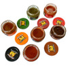 Pepper Puree Variety Pack, assortment of various hot pepper purees in glass jars with colorful lids, including green, red, orange, and dark brown varieties.