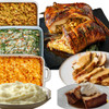 Creole Foods of Louisiana Large Traditional Turducken Feast, featuring a stuffed roasted turkey with poultry stuffing, side dishes including mashed potatoes, green bean casserole, macaroni and cheese, seasoned stuffing, and a dessert with bread pudding topped with whipped cream.