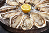 JV Foods Freshly Shucked Oysters (Quart), fresh oysters served on ice with lemon wedge