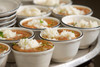 Parish Rice 5lb, bowls of cooked rice served with soup or stew in white bowls with black rims