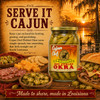 Cajun Chef Hot Pickled Okra 32oz product jar, pickled green okra spears in a glass jar with a golden lid, in front of a sunset at a Louisiana river with traditional Louisiana snacks and sandwiches around it.