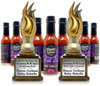 Bayou Gotham Ruby Rebelle Bourbon Cayenne Hot Sauce 5oz, bottles of spicy cayenne hot sauce with black caps and vibrant purple and black labels, accompanied by two gold flames trophies.